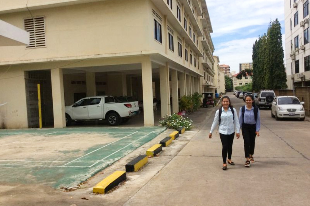 Two students walk outside the dormitories at the Royal University of Phnom Penh on September 13, 2019. (Chhorn Sopheap)