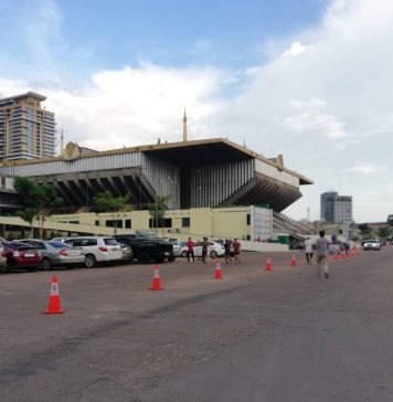 A small group of people job around Olympic Stadium grounds on the first day of its reopening, on July 28. (Nong Maichakreya)